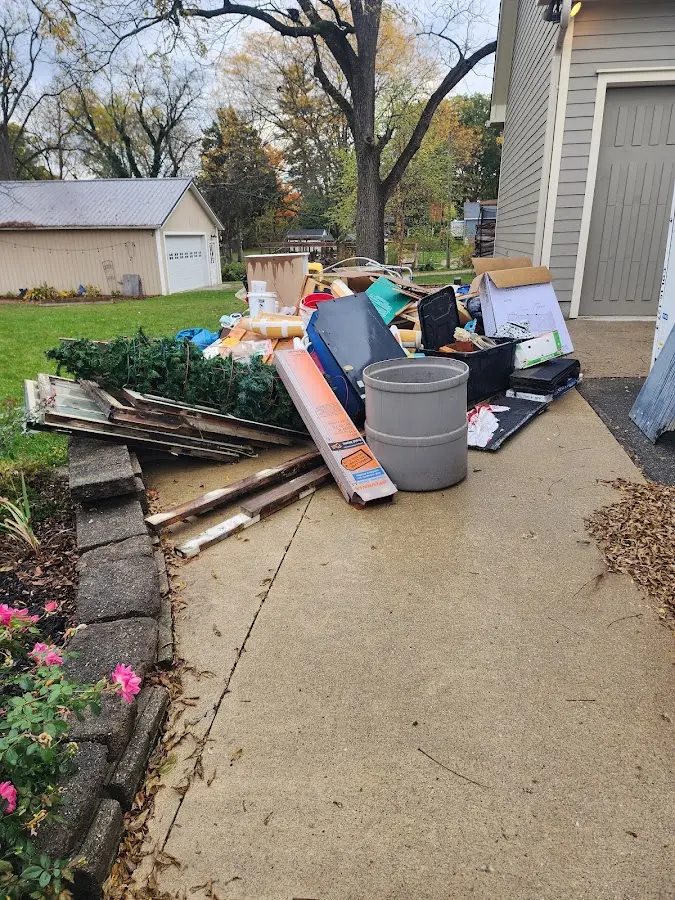 Dumpster being loaded with debris for Estate Cleanout Dumpster Rental in Canastota